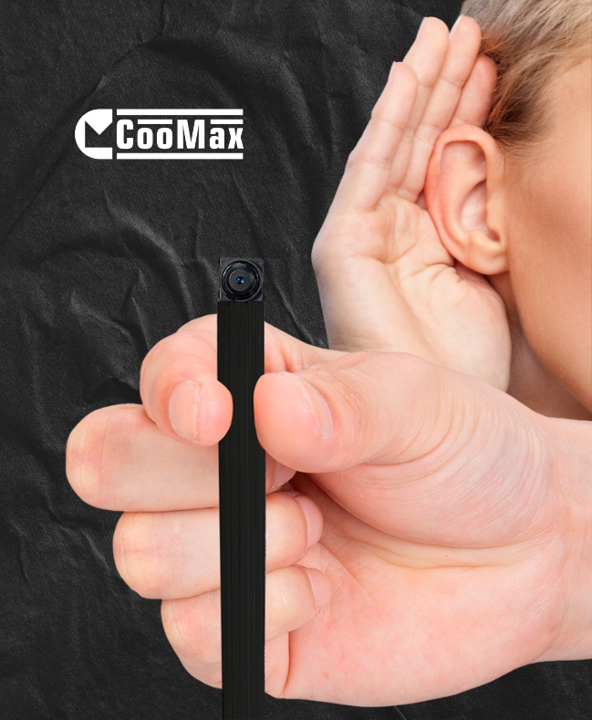 CooMax mini camera held in a hand beside an ear.