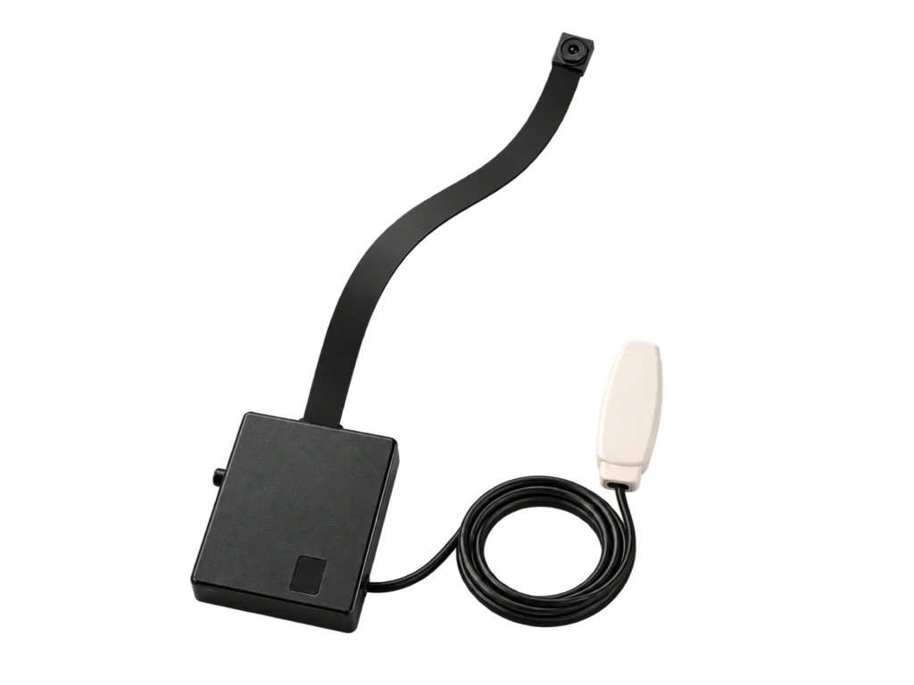 Editorial render of a compact camera module with a flat lens ribbon and coiled lead.